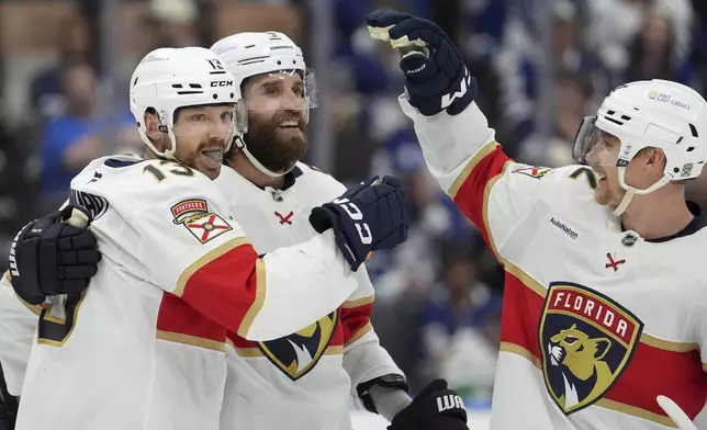 Florida Panthers centre Sam Reinhart (13) celebrates his goal with teammates Aaron Ekblad (5) and Gustav Forsling (42) during the third period of Game 7 of a second-round NHL hockey playoff series in Toronto, Sunday, May 18, 2025. (Frank Gunn/The Canadian Press via AP)