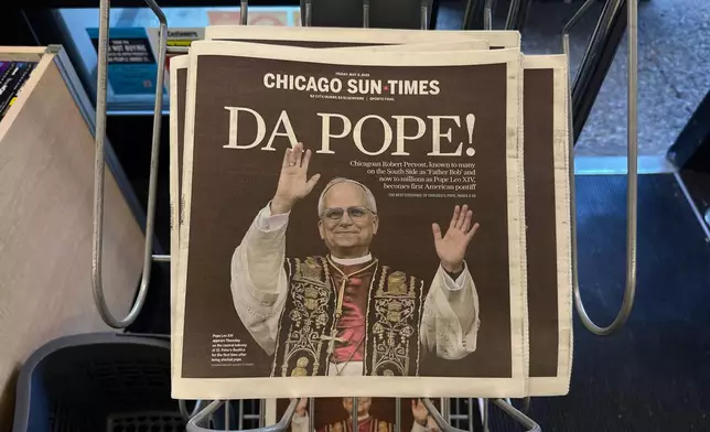 Chicago Sun Times newspaper front page showing Pope Leo XIV is seen on a newspaper rack at a store, Friday, May 9, 2025, in Chicago. (AP Photo/Melina Walling)