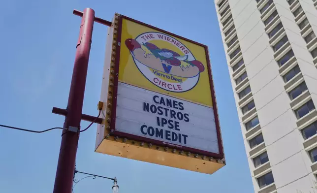 The Wiener's Circle, an iconic hot dog stand known for posting quirky phrases on its sign, posted on Instagram that its current sign translates to "He has eaten our dogs," Friday, May 9, 2025, in Chicago. (AP Photo/Erin Hooley)
