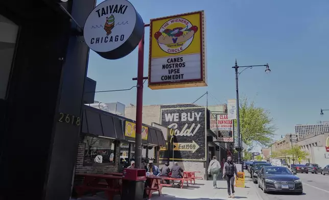 The Wiener's Circle, an iconic hot dog stand known for posting quirky phrases on its sign, posted on Instagram that its current sign translates to "He has eaten our dogs," Friday, May 9, 2025, in Chicago. (AP Photo/Erin Hooley)