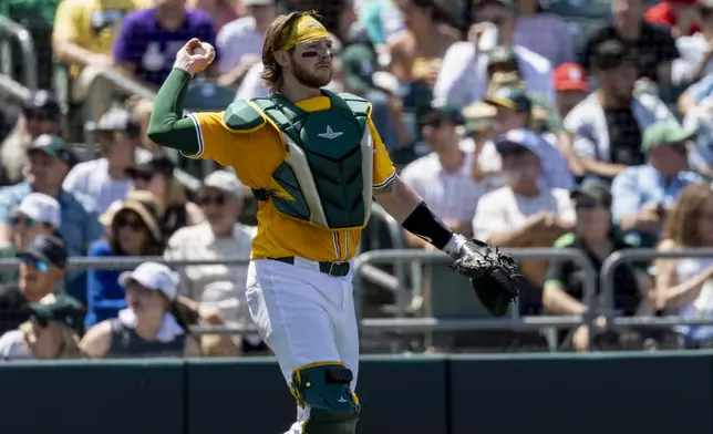Athletics catcher Willie MacIver throws the ball to the pitcher during the fifth inning of a baseball game against the Philadelphia Phillies, Sunday, May 25, 2025, in West Sacramento, Calif. (AP Photo/Sara Nevis)