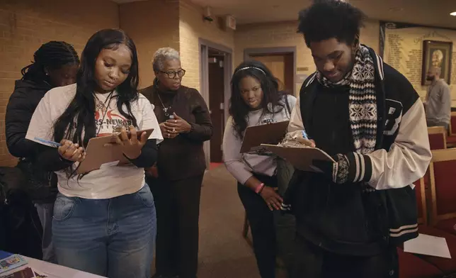 Students register to vote for school board elections during a Town Hall at the Bethany Baptist Church, Saturday, Feb. 1, 2025, in Newark, N.J. (AP Photo/Andres Kudacki)