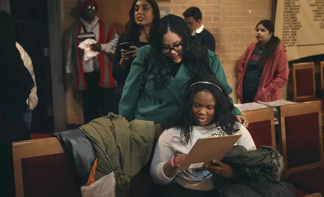 Students register to vote for school board elections during a Town Hall at the Bethany Baptist Church, Saturday, Feb. 1, 2025, in Newark, N.J. (AP Photo/Andres Kudacki)