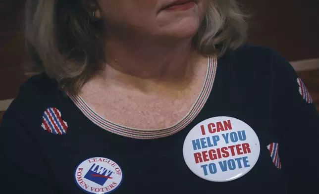 Voting activist Danna Ward listens to a speaker during a Town Hall and voter registration for school board elections at the Bethany Baptist Church, Saturday, Feb. 1, 2025, in Newark, N.J. (AP Photo/Andres Kudacki)