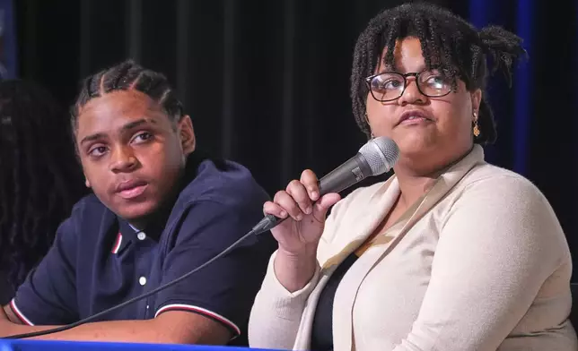 Makaila Nyambe, 17, right, and Deahmi Mobley, juniors at Perry Traditional Academy, question candidates in Pittsburgh's mayoral primary during a candidates forum in Pittsburgh, Thursday, April 24, 2025. (AP Photo/Gene J. Puskar)