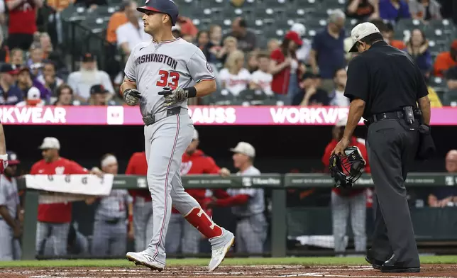Washington Nationals' Nathaniel Lowe (33) scores after hitting a home run during the second inning of a baseball game against the Baltimore Orioles, Friday, May 16, 2025, in Baltimore (AP Photo/Daniel Kucin Jr.)
