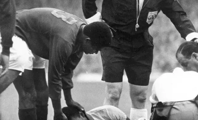 FILE - Brazilian star Pele lies in agony on the ground after being injured in a tackle during the Football World Cup match against Portugal at Goodison Park, Liverpool, on July 19, 1966. (AP Photo/Bippa)