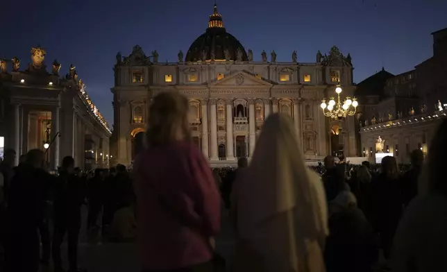 People gather in St Peter's Square as they wait to see the smoke billow from the chimney of the Sistine Chapel in St Peter's Square during the cardinals' conclave to elect a new pope, at the Vatican, Wednesday, May 7, 2025. (AP Photo/Francisco Seco)