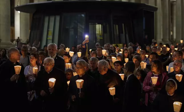 Faithful gather for a rosary prayer and a candlelight procession with the image of Mater Ecclesiae in St. Peter's Square at the Vatican,Saturday, May 3, 2025. (AP Photo/Bernat Armangue)