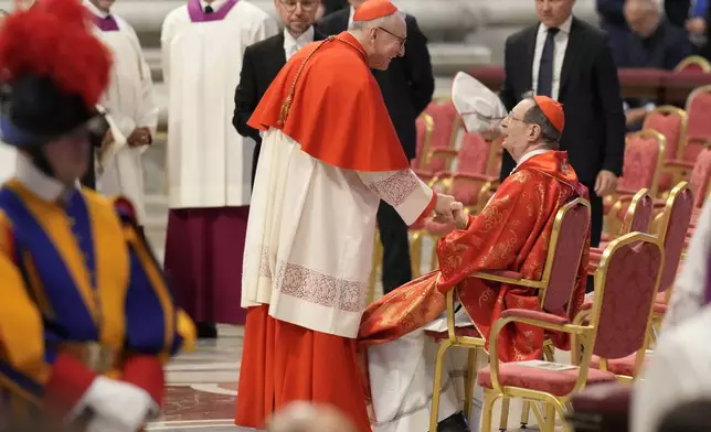 Cardinal Pietro Parolin, center, greets Cardinal Giovanni Lajolo during a final Mass celebrated by cardinals inside St. Peter's Basilica, before the conclave to elect a new pope, at the Vatican, Wednesday, May 7, 2025. (AP Photo/Gregorio Borgia)