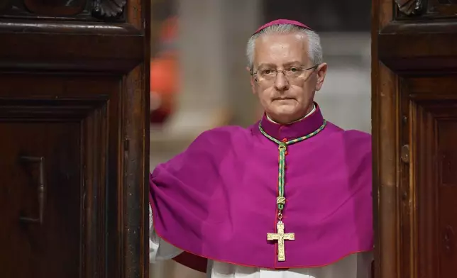 Vatican Master of Ceremonies, Archbishop Diego Giovanni Ravelli closes the doors of the Sistine Chapel at the Vatican to start the conclave to elect the successor of late Pope Francis, Wednesday, May 7, 2025. (Vatican Media via AP)