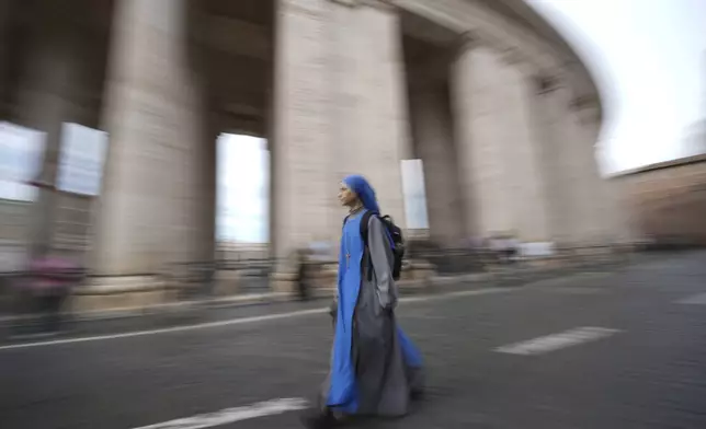 A nun walks past Bernini's colonnade near St. Peter's Square at the Vatican, Monday, May 5, 2025. (AP Photo/Andrew Medichini)