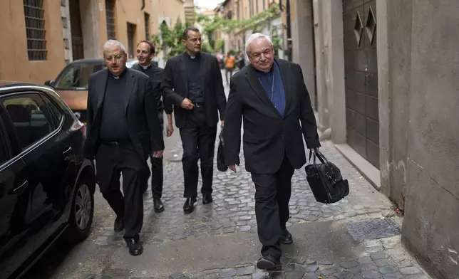 Cardinal Jean-Marc Aveline, foreground, walks in downtown Rome, Sunday, May 4, 2025. (AP Photo/Bernat Armangue)