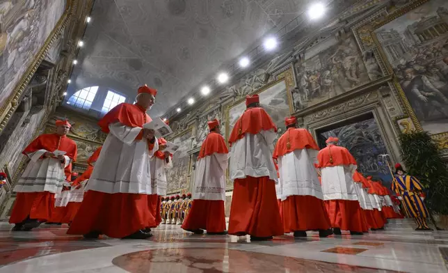 Cardinals make their way in the Sala Regia to enter the Sistine Chapel at the Vatican to start the conclave to elect the successor of late Pope Francis, Wednesday, May 7, 2025. (Vatican Media via AP)