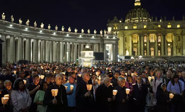In the foreground center to right: Cardinal Mauro Gambetti, Cardinal Dean Giovanni Battista Re, and Cardinal Lazarus You Heung-sik attend a rosary prayer and a candlelight procession with the image of Mater Ecclesiae in St. Peter's Square at the Vatican, Saturday, May 3, 2025. (AP Photo/Bernat Armangue)