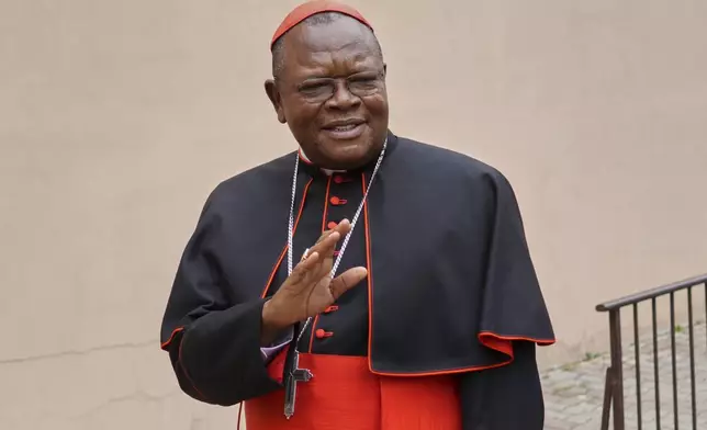 Cardinal Fridolin Ambongo Besungu arrives to celebrate Mass at his titular church, San Gabriele Arcangelo all'Acqua Traversa three days before the conclave to elect the 267th pope of the Roman Catholic Church, in Rome, Sunday, May 4, 2025. (AP Photo/Andrew Medichini)