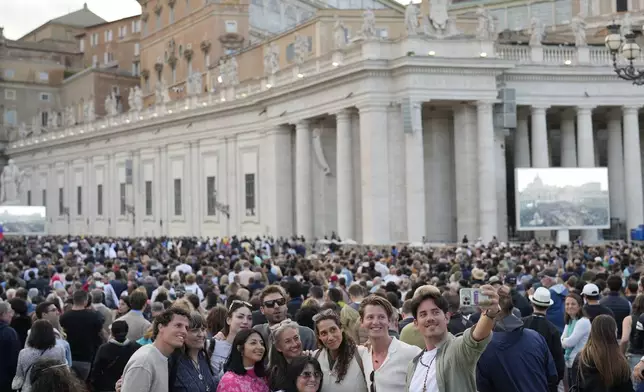 People wait for the smoke billowing from the chimney of the Sistine Chapel, where 133 cardinals are gathering on the first day of the conclave, indicating that a successor of late Pope Francis was elected or not, Wednesday, May 7, 2025. (AP Photo/Bernat Armangue)