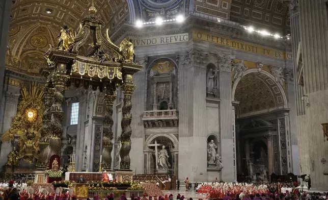 Cardinals, with white mitre hats, attend a final Mass inside St. Peter's Basilica, before the conclave to elect a new pope, at the Vatican, Wednesday, May 7, 2025. (AP Photo/Gregorio Borgia)