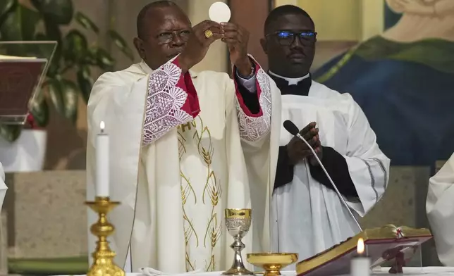 Cardinal Fridolin Ambongo Besungu celebrates Mass at his titular church, San Gabriele Arcangelo all'Acqua Traversa three days before the conclave to elect the 267th pope of the Roman Catholic Church, in Rome, Sunday, May 4, 2025. (AP Photo/Andrew Medichini)