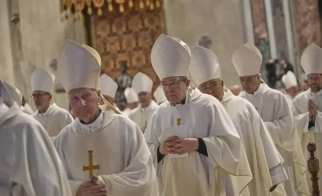 Cardinal Giuseppe Petrocchi, center, leaves at the end of a mass on the eight of nine days of mourning for late Pope Francis, in St. Peter's Basilica, at the Vatican, Saturday, May 3, 2025. (AP Photo/Alessandra Tarantino)