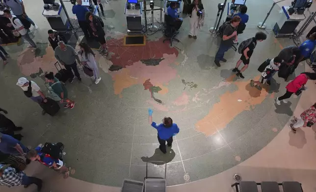 Travellers are directed to lines through security at Love Field airport, Friday, May 23, 2025, in Dallas. (AP Photo/LM Otero)