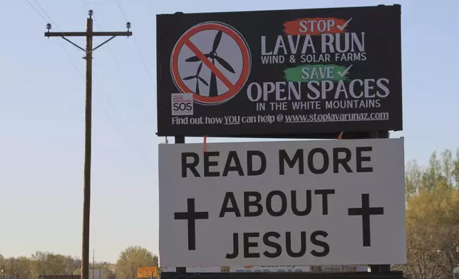 One of the billboards in opposition to an energy developer's plans for erecting more than 100 wind turbines across the grasslands and ancient lava fields is pictured just outside of Springerville, Ariz., Tuesday, April 22, 2025. (AP Photo/Susan Montoya Bryan)
