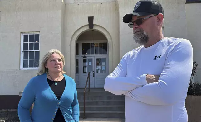 Town Manager Tim Rasmussen, right, and Mayor Shelly Reidhead discussing the economic importance of the coal-fired Springerville Generating Station, while standing outside town hall in Springerville, Ariz., Tuesday, April 22, 2025. (AP Photo/Susan Montoya Bryan)
