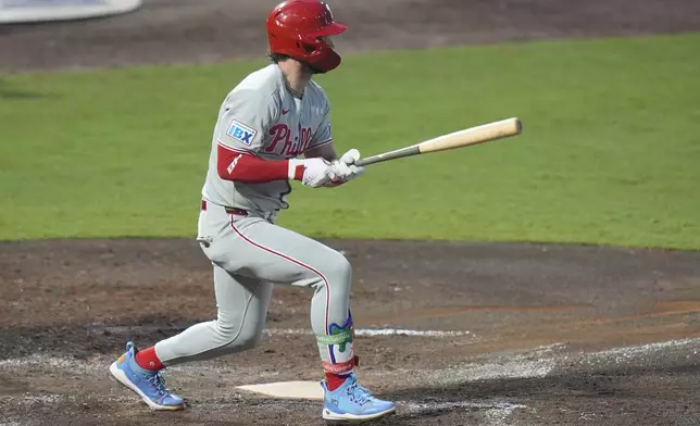 Philadelphia Phillies' Bryce Harper watches his two-run double off Tampa Bay Rays pitcher Shane Baz during the fourth inning of a baseball game Wednesday, May 7, 2025, in Tampa, Fla. (AP Photo/Chris O'Meara)
