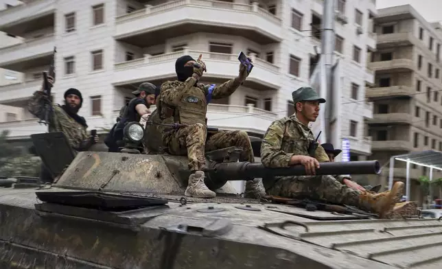 Members of Syria's security forces deploy in the town of Sahnaya, south of Damascus, on Wednesday, April 30, 2025, after earlier clashes with Druze fighters left at least 11 people dead. (AP Photo/Omar Albam)
