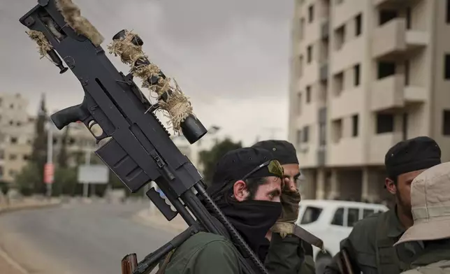 Members of Syria's security forces deploy during an operation in the edge of the town of Sahnaya, south of Damascus, Wednesday April 30, 2025. Clashes earlier in the area left at least 11 people dead a day after heavy exchange of fire between pro-government gunmen and Druze fighters in the Damascus suburb of Jaramana left 10 people dead.(AP Photo/Omar Albam)