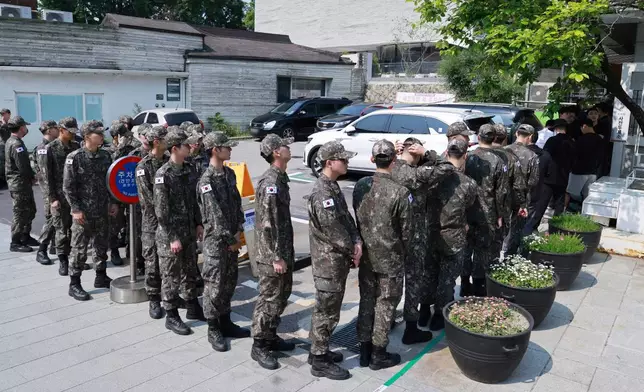 South Korean army soldiers wait in line to cast their early votes for the June 3 presidential election at a polling station in Seoul, South Korea, Thursday, May 29, 2025. (Hong Hae-in/Yonhap via AP)