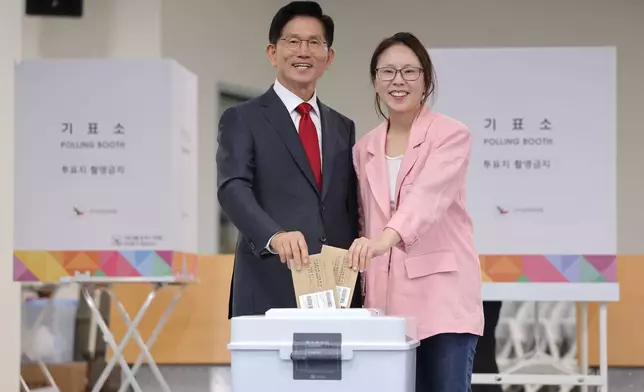 South Korean People Power Party's presidential candidate Kim Moon Soo and his daughter Kim Dong-ju cast their early votes for the June 3 presidential election at a polling station in Incheon, South Korea, Thursday, May 29, 2025. (Ryu Young-seok/Yonhap via AP)