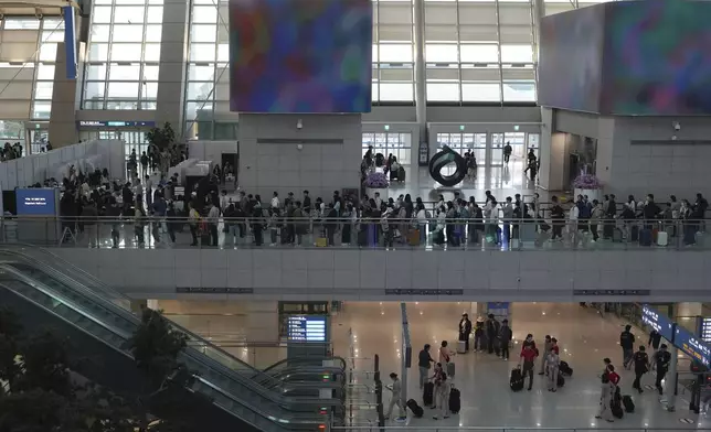 Voters queue to cast their early votes for the June 3 presidential election at a polling station at the departure hall of Incheon International Airport in Incheon, South Korea, Thursday, May 29, 2025. (AP Photo/Lee Jin-man)