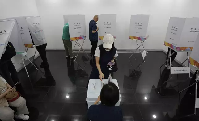 A woman casts her early vote for the June 3 presidential election at a polling station in Seoul, South Korea, Friday, May 30, 2025. (AP Photo/Ahn Young-joon)