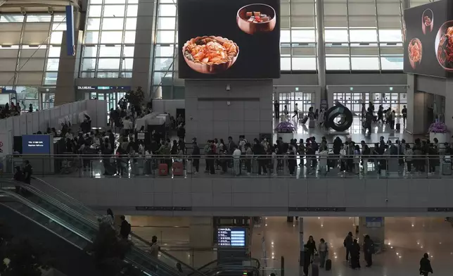Voters queue to cast their early votes for the June 3 presidential election at a polling station at the departure hall of Incheon International Airport in Incheon, South Korea, Thursday, May 29, 2025. (AP Photo/Lee Jin-man)