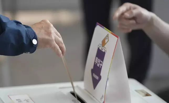 A voter casts early vote for the June 3 presidential election at a polling station at the departure hall of Incheon International Airport in Incheon, South Korea, Thursday, May 29, 2025. (AP Photo/Lee Jin-man)