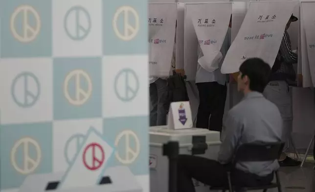 Voters cast their early votes for the June 3 presidential election at a polling station at the departure hall of Incheon International Airport in Incheon, South Korea, Thursday, May 29, 2025. (AP Photo/Lee Jin-man)