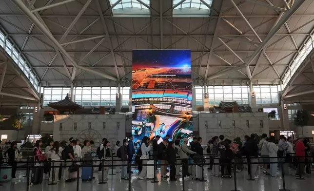 Voters queue to cast their early votes for the June 3 presidential election at a polling station at the departure hall of Incheon International Airport in Incheon, South Korea, Thursday, May 29, 2025. (AP Photo/Lee Jin-man)