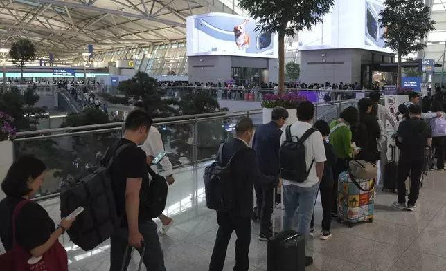 Voters queue to cast their early votes for the June 3 presidential election at a polling station at the departure hall of Incheon International Airport in Incheon, South Korea, Thursday, May 29, 2025. (AP Photo/Lee Jin-man)