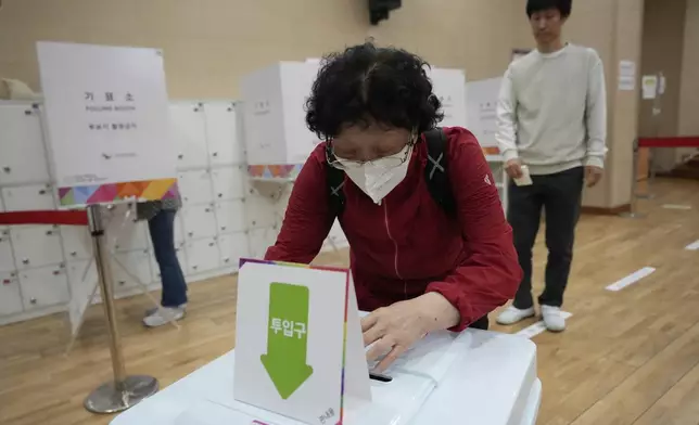A woman casts her early vote for the June 3 presidential election at a polling station in Seoul, South Korea, Thursday, May 29, 2025. (AP Photo/Ahn Young-joon)