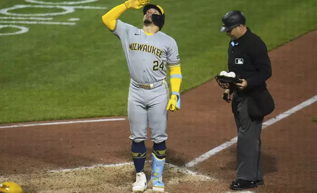 Milwaukee Brewers' William Contreras (24) celebrates as he stands on home plate after hitting a solo home run off Pittsburgh Pirates pitcher David Bednar (not shown) during the ninth inning of a baseball game in Pittsburgh, Friday, May 23, 2025. (AP Photo/Gene J. Puskar)