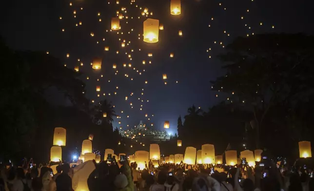 Devotees fly lanterns during the commemoration of Vesak, which marks the day of Buddha's birth, death and enlightenment at the 9th-century Borobudur Temple in Magelang, Central Java, Indonesia, late Monday, May 12, 2025. (AP Photo/Slamet Riyadi)