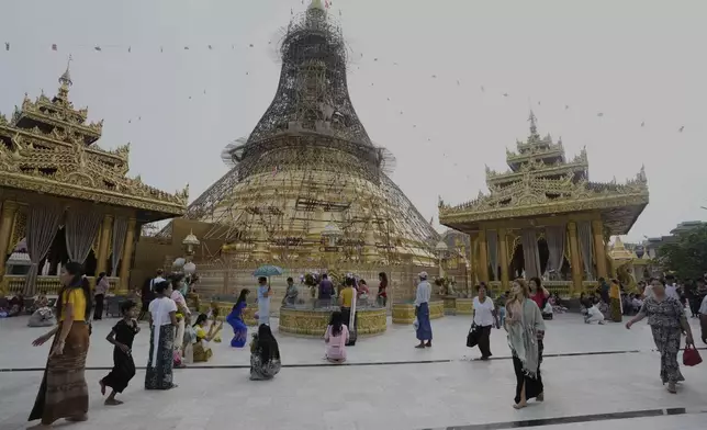 Buddhist devotees visit Botataung pagoda during a religious ceremony to mark the Full Moon day of "Kasone," known as Buddha's Birthday, Sunday, May 11, 2025, in Yangon, Myanmar. (AP Photo/Thein Zaw)