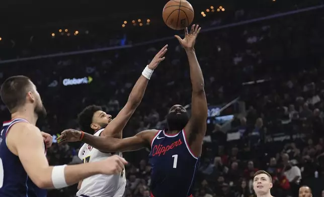 Los Angeles Clippers guard James Harden, right, shoots as Denver Nuggets guard Jamal Murray defends during the first half in Game 6 of an NBA basketball first-round playoff series Thursday, May 1, 2025, in Inglewood, Calif. (AP Photo/Mark J. Terrill)