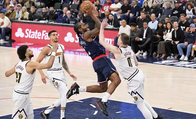 Los Angeles Clippers forward Kawhi Leonard, second from right, shoots as Denver Nuggets guard Jamal Murray, left, forward Michael Porter Jr., second from left, and guard Christian Braun defend during the second half in Game 6 of an NBA basketball first-round playoff series Thursday, May 1, 2025, in Inglewood, Calif. (AP Photo/Mark J. Terrill)