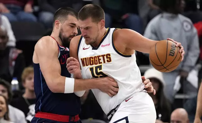 Denver Nuggets center Nikola Jokic, right, drives against Los Angeles Clippers center Ivica Zubac during the first half in Game 6 of an NBA basketball first-round playoff series Thursday, May 1, 2025, in Inglewood, Calif. (AP Photo/Mark J. Terrill)