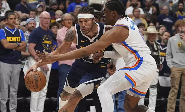 Denver Nuggets forward Aaron Gordon, left, drives past Oklahoma City Thunder forward Jalen Williams, right, in the first half of Game 4 in the Western Conference semifinals of the NBA basketball playoffs Sunday, May 11, 2025, in Denver. (AP Photo/David Zalubowski)