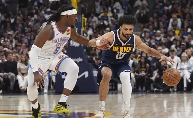 Denver Nuggets guard Jamal Murray, right, struggles to move the ball as Oklahoma City Thunder guard Luguentz Dort, left, defends in the first half of Game 4 in the Western Conference semifinals of the NBA basketball playoffs Sunday, May 11, 2025, in Denver. (AP Photo/David Zalubowski)