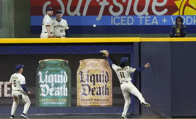 Milwaukee Brewers' Jackson Chourio (11) is unable to catch a fly ball during the seventh inning of a baseball game against the Baltimore Orioles, Tuesday, May 20, 2025, in Milwaukee. (AP Photo/Aaron Gash)