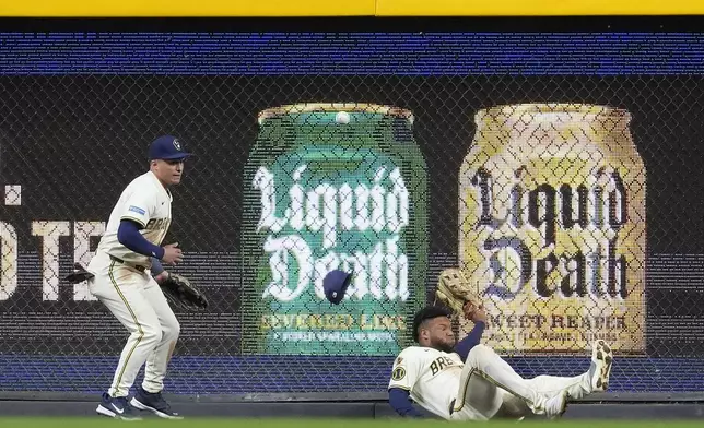 Milwaukee Brewers' Jackson Chourio, right, is unable to catch a fly ball during the seventh inning of a baseball game against the Baltimore Orioles, Tuesday, May 20, 2025, in Milwaukee. (AP Photo/Aaron Gash)